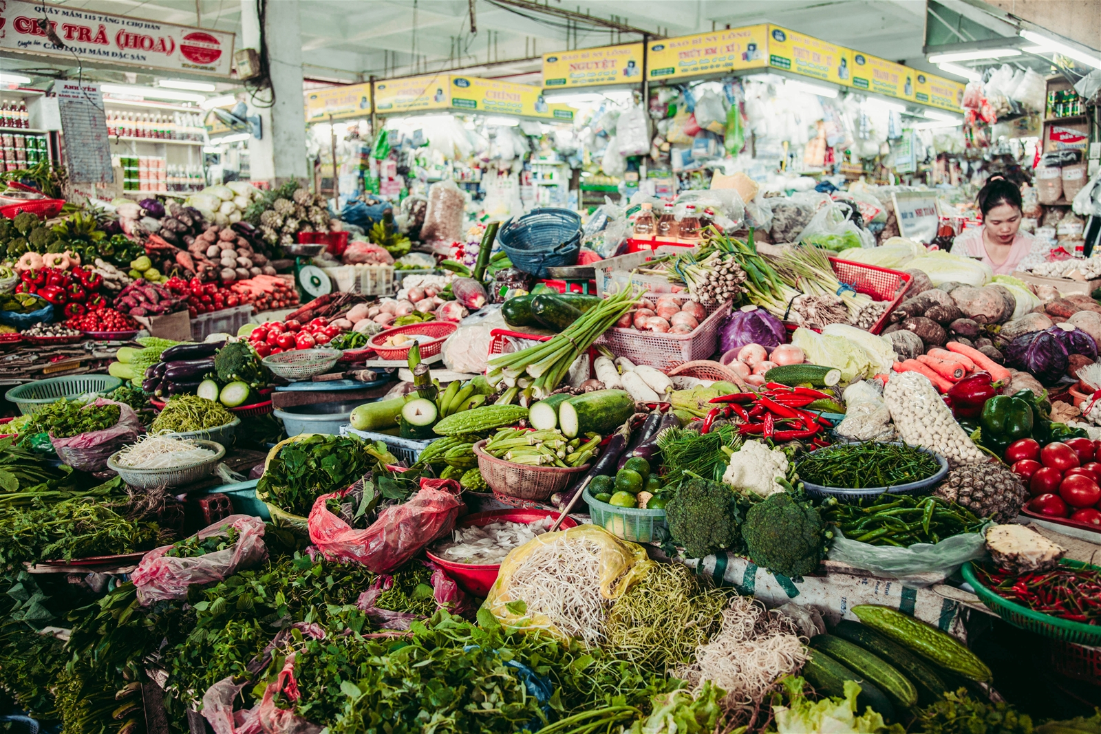 Fresh produce vendors at Han Market in Da Nang selling local vegetables, herbs, and ingredients used in Vietnamese cuisine