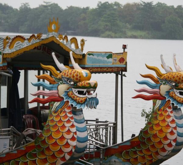 Traditional dragon boat cruising on the Perfume River in Hue, Vietnam