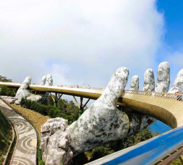 Travelers visiting the iconic Golden Bridge at Ba Na Hills on a day tour from Hoi An.
