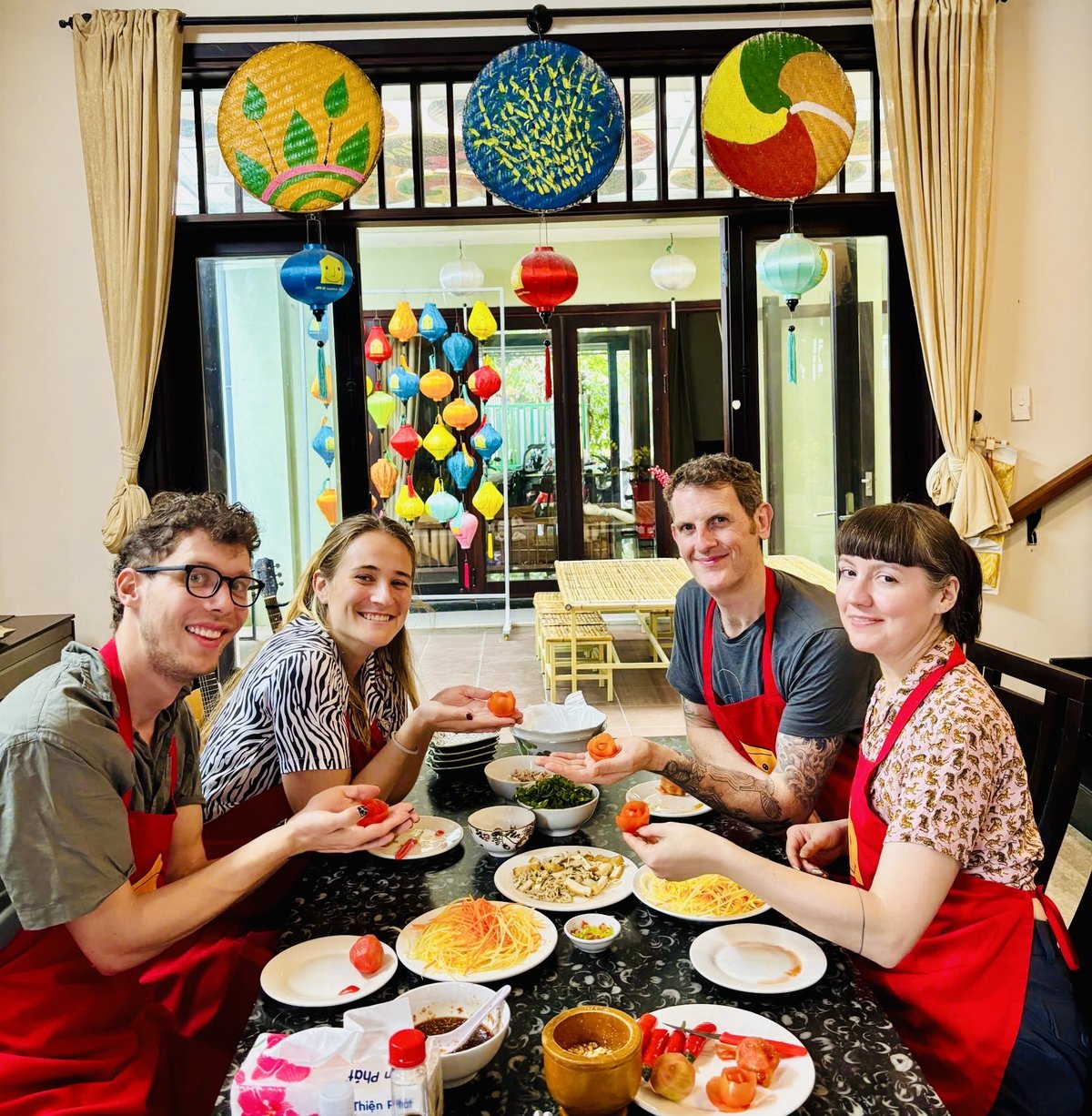 Happy guests showing their dishes at a Da Nang cooking class with Jolie