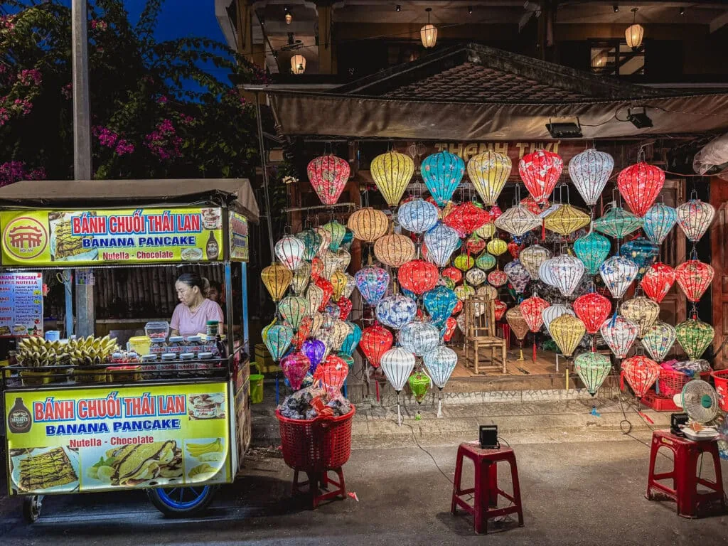 Lantern-lit streets of Hoi An at night during an evening food tour